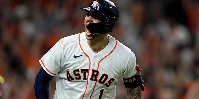 Houston Astros' Carlos Correa celebrates a home run against the Boston Red Sox during the seventh inning in Game 1 of baseball's American League Championship Series Friday, Oct. 15, 2021, in Houston.
