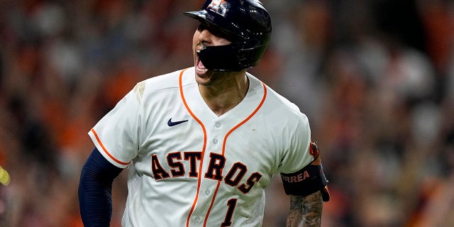 Houston Astros' Carlos Correa celebrates a home run against the Boston Red Sox during the seventh inning in Game 1 of baseball's American League Championship Series Friday, Oct. 15, 2021, in Houston.