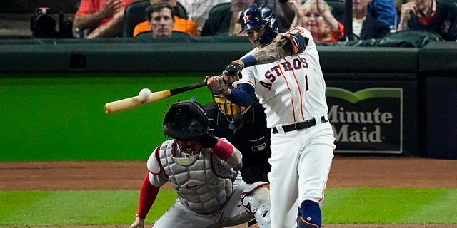 Houston Astros' Carlos Correa hits a home run against the Boston Red Sox during the seventh inning in Game 1 of baseball's American League Championship Series Friday, Oct. 15, 2021, in Houston. 