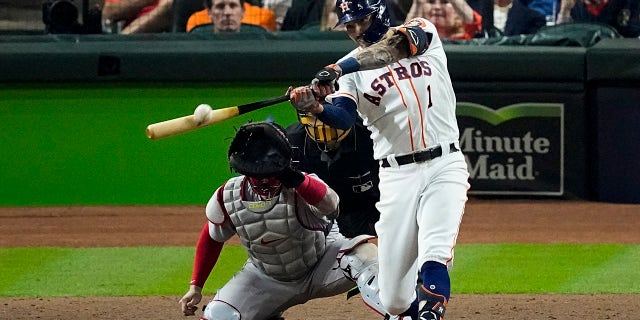 Houston Astros' Carlos Correa hits a home run against the Boston Red Sox during the seventh inning in Game 1 of baseball's American League Championship Series Friday, Oct. 15, 2021, in Houston.