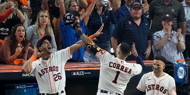 The Houston Astros' Carlos Correa celebrates a home run against the Boston Red Sox during the seventh inning in Game 1 of baseball's American League Championship Series Friday, Oct. 15, 2021, in Houston.