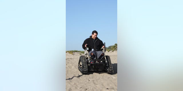 Veteran Carols Garcia with a customized all-terrain wheelchair from Freedom Alliance. 