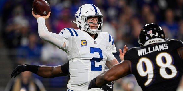 Indianapolis Colts quarterback Carson Wentz (2) throws the ball under pressure from Baltimore Ravens nose tackle Brandon Williams (98) during the first half of an NFL football game, Monday, Oct. 11, 2021, in Baltimore.