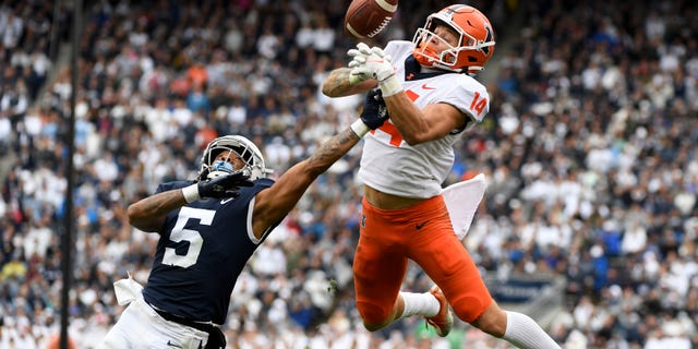 Penn State cornerback Tariq Castro-Fields (5) breaks up a pass intended for Illinois wide receiver Casey Washington (14) during the second half of an NCAA college football game in State College, Pa.on Saturday, Oct. 23, 2021. Illinois defeated Penn State 20-18 in nine overtimes.