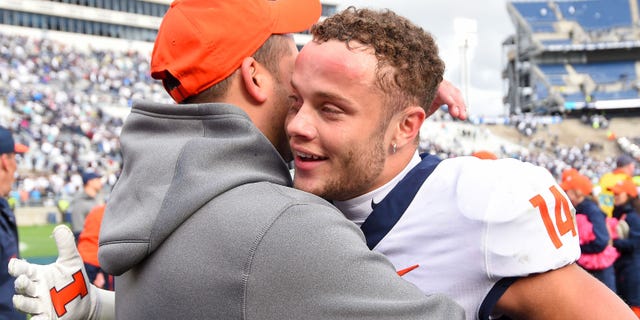 Oct 23, 2021; University Park, Pennsylvania, USA; Illinois Fighting Illini wide receiver Casey Washington (right) celebrates following the game against the Penn State Nittany Lions at Beaver Stadium.