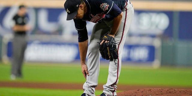 Atlanta Braves starting pitcher Charlie Morton rubs his leg in the third inning of Game 1 in the World Series between the Houston Astros and the Atlanta Braves Tuesday, Oct. 26, 2021, in Houston.