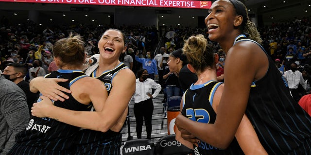 Chicago Sky's Astou Ndour-Fall, right, Courtney Vandersloot (22), Stefanie Dolson second from left, and Allie Quigley celebrate after the Sky defeated the Connecticut Sun 79-69 in Game 4 of a WNBA basketball semifinal series Wednesday, Oct. 6, 2021, in Chicago.