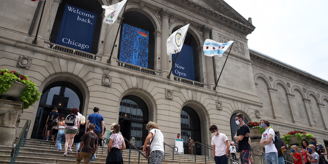 People line up outside the Art institute of Chicago as the museum re-opens on Thursday, July 30, 2020 in Chicago. The museum had been shuttered due to the COVID-19 virus pandemic. (Terrence Antonio James/Chicago Tribune/Tribune News Service via Getty Images)