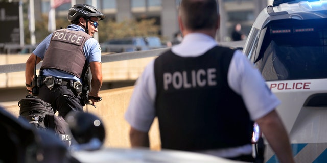 Chicago police officers work at the scene near where two officers were shot at 63rd Street and Bell Avenue in Chicago on Aug. 7. (Chris Sweda/Chicago Tribune/Tribune News Service via Getty Images)