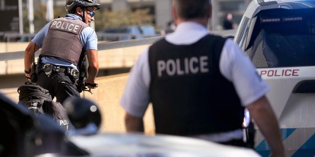 Chicago police officers at the scene of the 63rd Street and Bell Avenue shootings in Chicago.