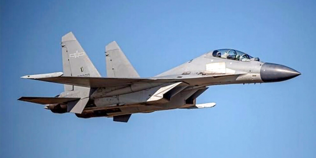 A Chinese PLA J-16 fighter jet flies in an undisclosed location in this undated file.