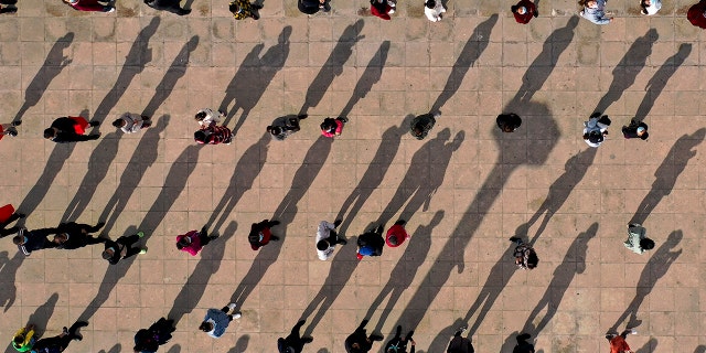 This photo released by Xinhua News Agency shows an aerial view of residents lining up to receive a swab for the coronavirus test during a mass testing in Xingqing District of Yinchuan in northwest China's Ningxia Hui Autonomous Region on Saturday.