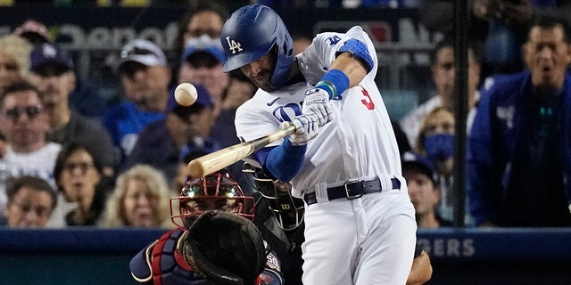 Los Angeles Dodgers' Chris Taylor hits an RBI single in the third inning against the Atlanta Braves in Game 5 of baseball's National League Championship Series Thursday, Oct. 21, 2021, in Los Angeles.