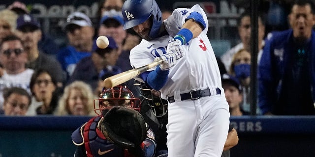 Los Angeles Dodgers' Chris Taylor hits an RBI single in the third inning against the Atlanta Braves in Game 5 of baseball's National League Championship Series Thursday, Oct. 21, 2021, in Los Angeles.