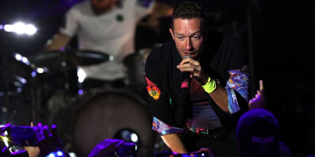 Chris Martin of Coldplay performs live on stage at O2 Arena Shepherd's Bush Empire on October 12, 2021 in London, England. The same night he serenaded girlfriend Dakota Johnson with the song ‘Universe.’