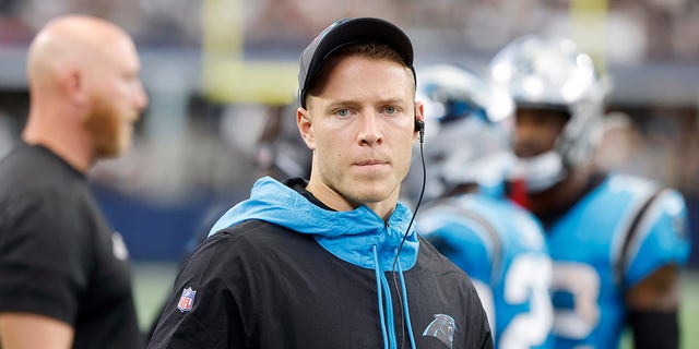 FILE - In this Sunday, Oct. 3, 2021, file photo, Carolina Panthers running back Christian McCaffrey watches play from the sideline during the first half of a NFL football game against the Dallas Cowboys in Arlington, Texas. McCaffrey did not practice Thursday, Oct. 14, 2021, a sign that he could miss his third straight game while trying to rehab from a hamstring injury.