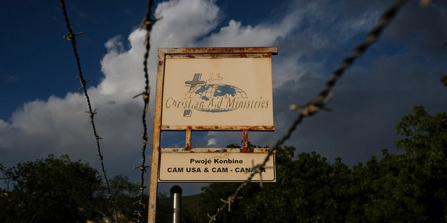 A custom sign stands outside Christian Aid Ministries in Titanyen, Haiti, Thursday, Oct. 21, 2021.  
