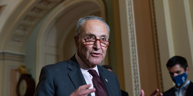 Senate Majority Leader Chuck Schumer of New York speaks to the media after a Democratic political luncheon October 19, 2021, on Capitol Hill in Washington. 