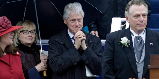 FILE – Former President Bill Clinton, center, and former Secretary of State Hillary Rodham Clinton look on as Virginia Gov. Terry McAuliffe prepares to deliver his inaugural address during ceremonies at the Capitol in Richmond, Va., Saturday, Jan. 11, 2014. Also pictured at left is Virginia first lady Dorothy McAuliffe. (AP Photo/Patrick Semansky)
