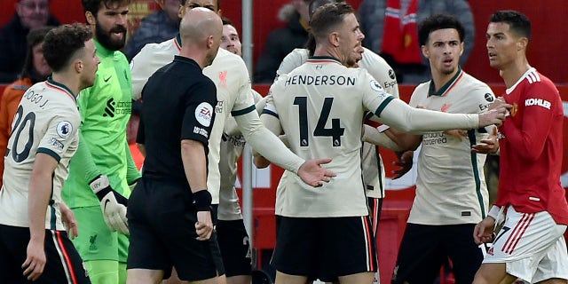 Liverpool players argue with Manchester United's Cristiano Ronaldo, right, during the English Premier League soccer match between Manchester United and Liverpool at Old Trafford in Manchester, England, Sunday, Oct. 24, 2021.