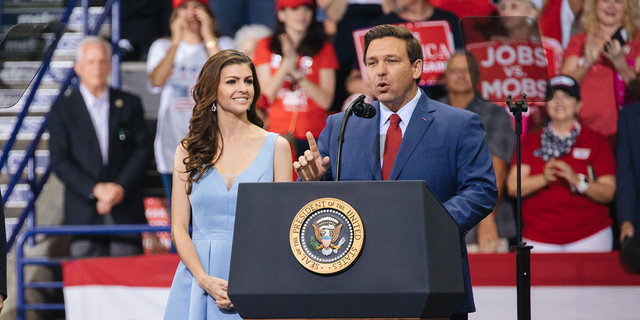 Rep. Ron DeSantis, then a Republican candidate for governor of Florida, speaks as his wife, Casey DeSantis, looks on during a campaign rally in Estero, Florida, Oct. 31, 2018.
