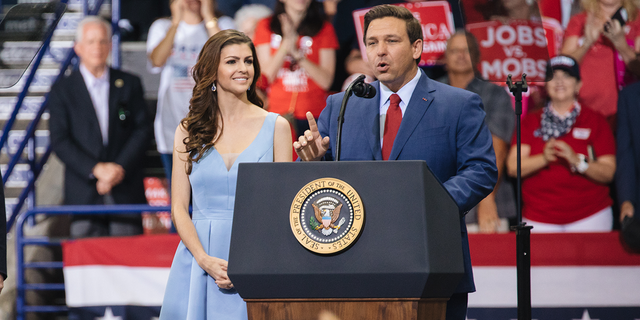 Rep. Ron DeSantis, then a Republican candidate for governor of Florida, speaks as his wife, Casey DeSantis, looks on during a campaign rally in Estero, Florida, Oct. 31, 2018.