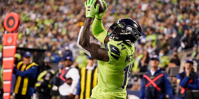 Seattle Seahawks wide receiver D.K. Metcalfe catches Geno Smith's pass in the second half of the NFL football game on Thursday, October 7, 2021, to make a touchdown against the Los Angeles Rams in Seattle.