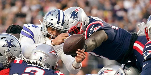 New England Patriots middle linebacker Ja'Whaun Bentley, right, knocks the ball out of the hands of Dallas Cowboys quarterback Dak Prescott, left, on a touchdown attempt at the goal line during the first half Sunday, Oct. 17, 2021, in Foxborough, Mass.