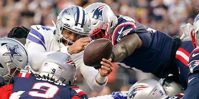 New England Patriots middle linebacker Ja'Whaun Bentley, right, knocks the ball out of the hands of Dallas Cowboys quarterback Dak Prescott, left, on a touchdown attempt at the goal line during the first half Sunday, Oct. 17, 2021, in Foxborough, Mass.