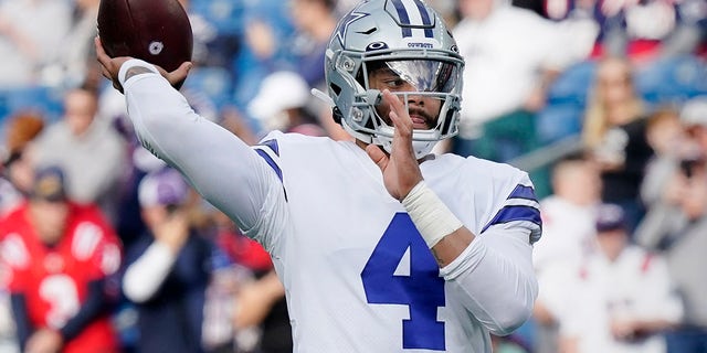Dallas Cowboys quarterback Dak Prescott (4) warms up prior to an NFL football game against the New England Patriots, Sunday, Oct. 17, 2021, in Foxborough, Mass.
