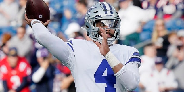 Dallas Cowboys quarterback Dak Prescott (4) warms up prior to an NFL football game against the New England Patriots, Sunday, Oct. 17, 2021, in Foxborough, Mass.