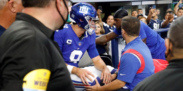 New York Giants' Daniel Jones (8) is carted off the field after suffering an unknown injury running the ball in the first half of a game against the Dallas Cowboys in Arlington, Texas, Sunday, Oct. 10, 2021.