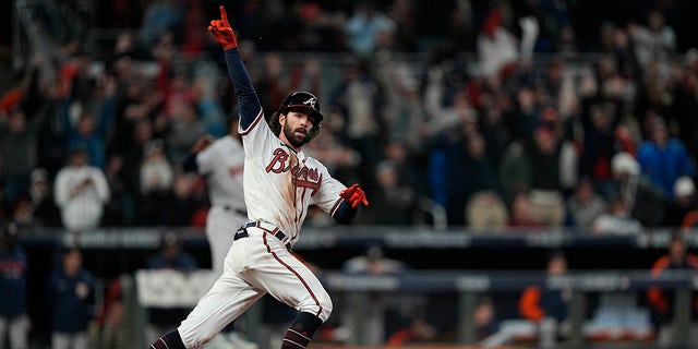 Atlanta Braves' Dansby Swanson celebrates his home run during the seventh inning in Game 4 of baseball's World Series between the Houston Astros and the Atlanta Braves Saturday, Oct. 30, 2021, in Atlanta.