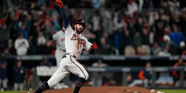 Atlanta Braves' Dansby Swanson celebrates his home run during the seventh inning in Game 4 of baseball's World Series between the Houston Astros and the Atlanta Braves Saturday, Oct. 30, 2021, in Atlanta.