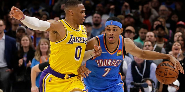 Oklahoma City Thunder forward Darius Bazley (7) goes against Los Angeles Lakers guard Russell Westbrook (0) during the second half of an NBA basketball game, Wednesday, Oct. 27, 2021, in Oklahoma City. 