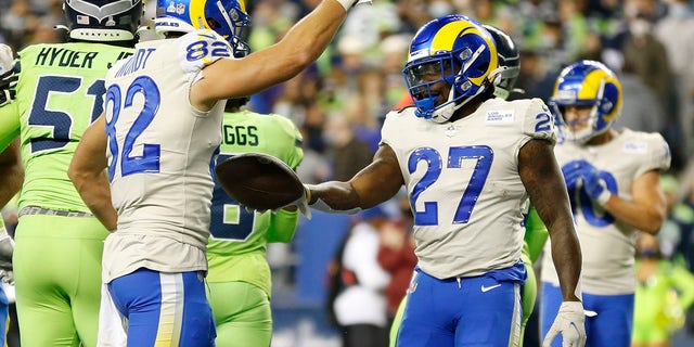 Retired Los Angeles Rams' Darrell Henderson (27) passes the ball to Johnny Mundt (82) after Henderson scored against the Seattle Seahawks in the second half of an NFL football game on Thursday, October 7, 2021. Seattle.