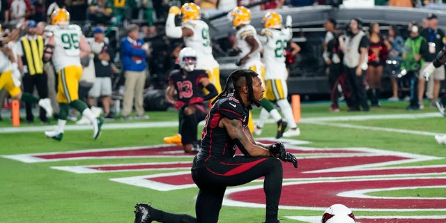Arizona Cardinals wide receiver DeAndre Hopkins kneels after the Green Bay Packers intercepted the ball in the end zone during the second half of an NFL football game, Thursday, Oct. 28, 2021, in Glendale, Arizona. The Packers won 24-21.