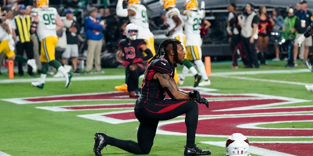Arizona Cardinals wide receiver DeAndre Hopkins kneels after the Green Bay Packers intercepted the ball in the end zone during the second half of an NFL football game, Thursday, Oct. 28, 2021, in Glendale, Arizona. The Packers won 24-21.