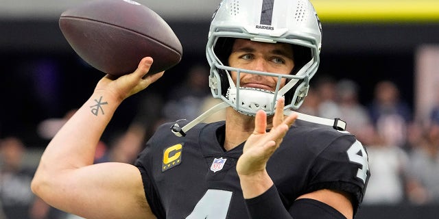 Las Vegas Raiders quarterback Derek Carr (4) warms up before an NFL football game against the Chicago Bears, Sunday, Oct. 10, 2021, in Las Vegas.