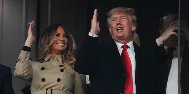 Former President Donald Trump and his wife Melania perform the tomahawk chop before Game 4 of baseball's World Series between the Houston Astros and the Atlanta Braves Saturday, Oct. 30, 2021, in Atlanta.