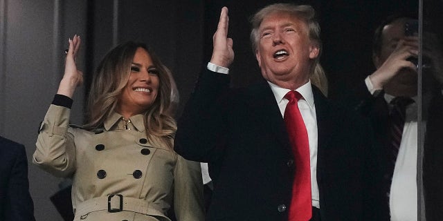 Former President Donald Trump and his wife Melania perform the tomahawk chop before Game 4 of baseball's World Series between the Houston Astros and the Atlanta Braves Saturday, Oct. 30, 2021, in Atlanta.