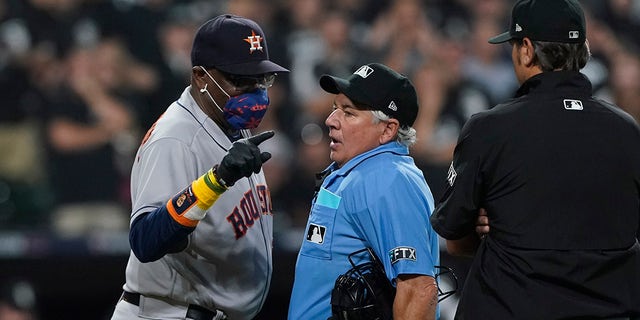 Houston Astros manager Dusty Baker Jr. (12) points to the foul line while arguing with home plate umpire Tom Hallion in the fourth inning during Game 3 of a baseball American League Division Series Sunday, Oct. 10, 2021, in Chicago.