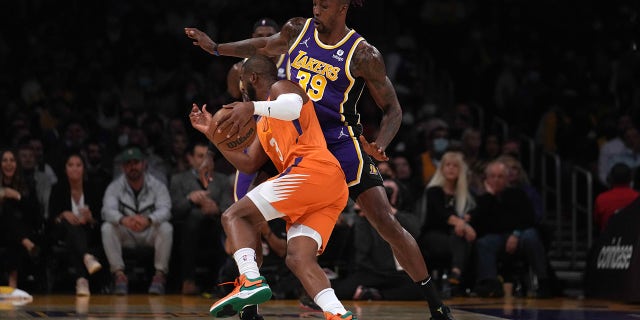 Oct 22, 2021; Los Angeles, California, USA; Phoenix Suns guard Chris Paul (3) is defended by Los Angeles Lakers center Dwight Howard (39) in the first half at Staples Center.