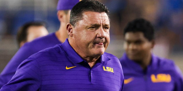 LSU coach Ed Orgeron runs off the field with his team before an NCAA college football game against Kentucky in Lexington, Ky., Saturday, Oct. 9, 2021.