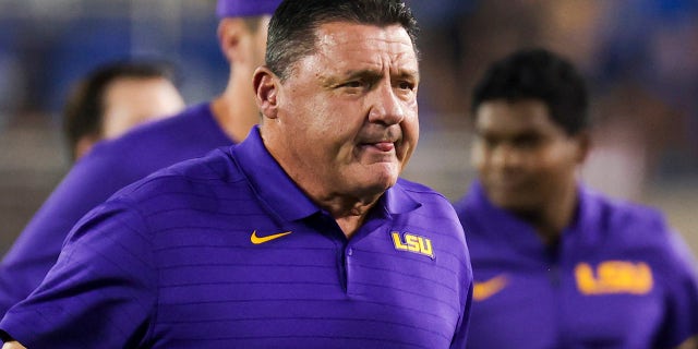 LSU coach Ed Orgeron runs off the field with his team before an NCAA college football game against Kentucky in Lexington, Ky., Saturday, Oct. 9, 2021.