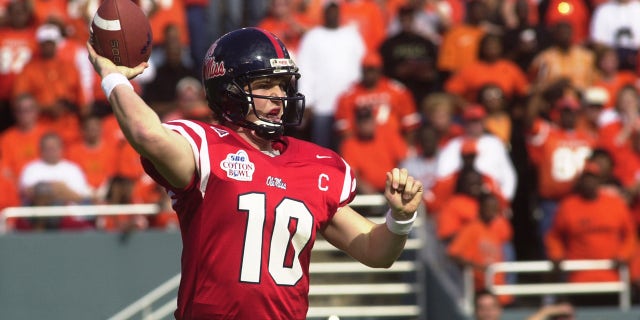 Eli Manning, #10 quarterback of the University of Mississippi Rebels football team throws the ball up field to an open receiver during the game against the Oklahoma State University Cowboys on Jan. 2, 2004 at Cotton Bowl Stadium in Dallas, Texas. The Rebels won 31-28.