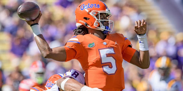 Florida quarterback Emory Jones (5) is pressured by LSU defensive end BJ Ojulari (8) in the first half of an NCAA college football game in Baton Rouge, La., Saturday, Oct. 16, 2021.
