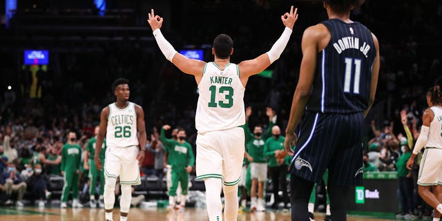 October 4, 2021;  Boston, Massachusetts, United States;  Boston Celtics center Enes Kanter (13) reacts after goaltender Romeo Langford (9) scored three points in the second half against the Orlando Magic at TD Garden.