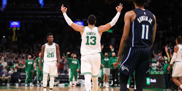 October 4, 2021; Boston, Massachusetts, United States; Boston Celtics center Enes Kanter (13) reacts after goaltender Romeo Langford (9) scored three points in the second half against the Orlando Magic at TD Garden.