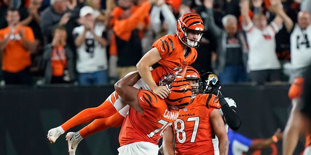 Cincinnati Bengals kicker Evan McPherson (2) celebrates with Jackson Carman (79) after kicking the game-winning field goal against the Jacksonville Jaguars in an NFL football game, Thursday, Sept. 30, 2021, in Cincinnati. Cincinnati won 24-21.